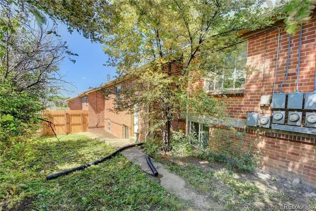 a backyard of a building with large trees