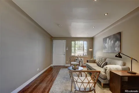 a living room with fireplace furniture and a window