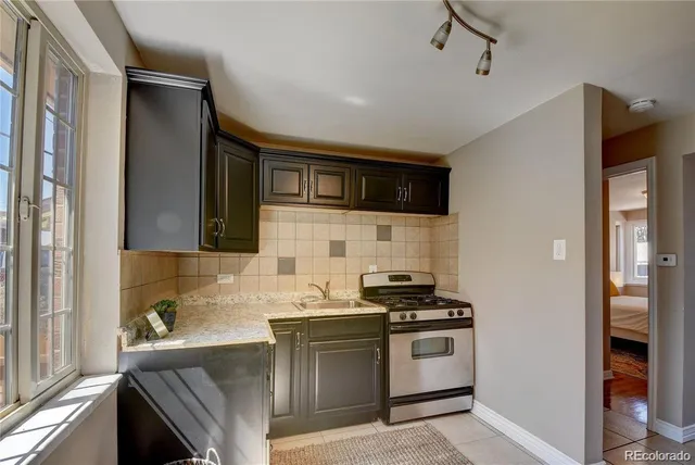 a kitchen with stainless steel appliances a sink stove and refrigerator