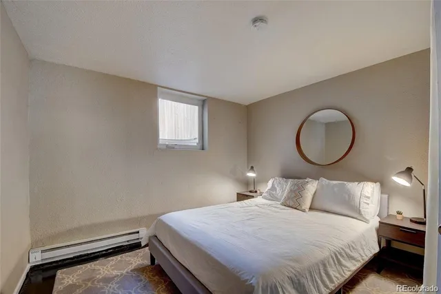 a bed sitting in a bedroom next to a window