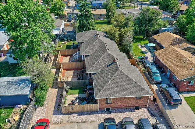 a view of a house with wooden stairs and a table and chairs