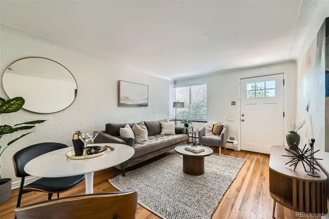 a living room with furniture and a mirror