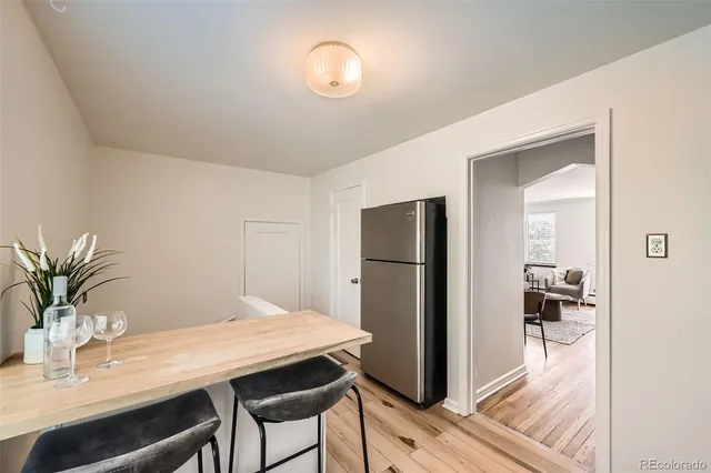 a view of a dining room with a table and chairs