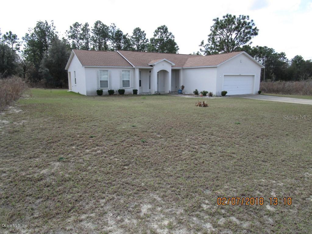 6926 Southwest 129th Street Ocala, FL 34473 - Photo 1 of 1 a view of a yard in front of a house with large tree