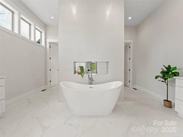 a white bath tub sitting in a bathroom