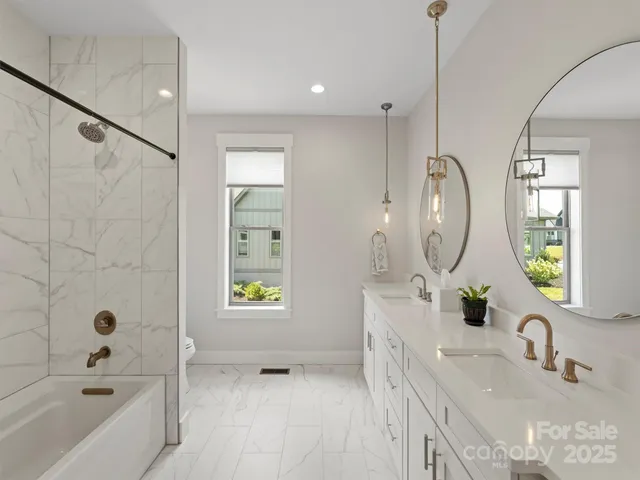 a bathroom with a tub sink and mirror