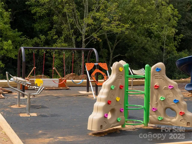 a view of outdoor space with swings and slides