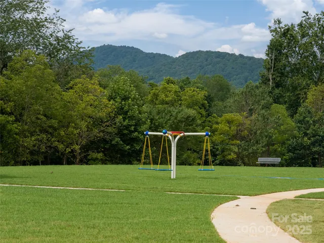 a view of a white house with a big yard and palm trees