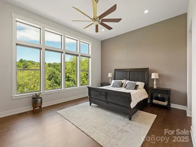 a white bed sitting in a room next to a window