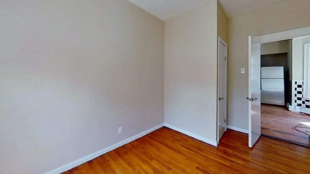 121 George Street, Unit 1 Boston, MA 02119 - Photo 4 of 7 a view of empty room with wooden floor