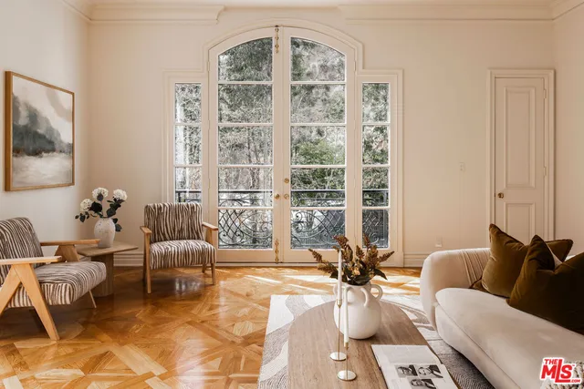 a living room with a bed and a large window