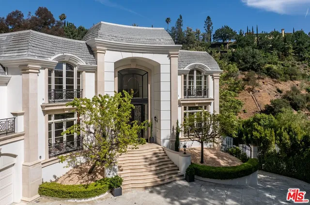 a aerial view of a house with a yard and garden