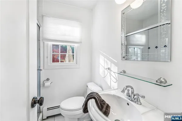 a white toilet sitting next to a bathroom sink