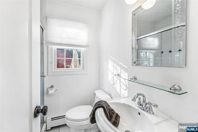 a white toilet sitting next to a bathroom sink