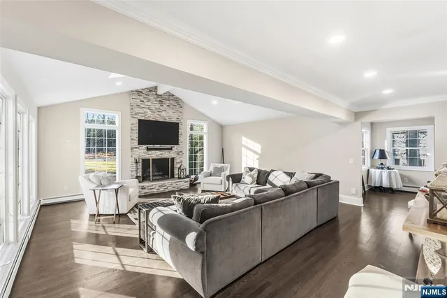a living room with furniture fireplace and a flat screen tv