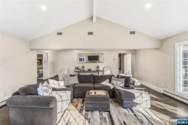 a living room with furniture potted plant and a window