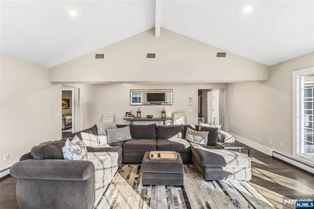 a living room with furniture potted plant and a window