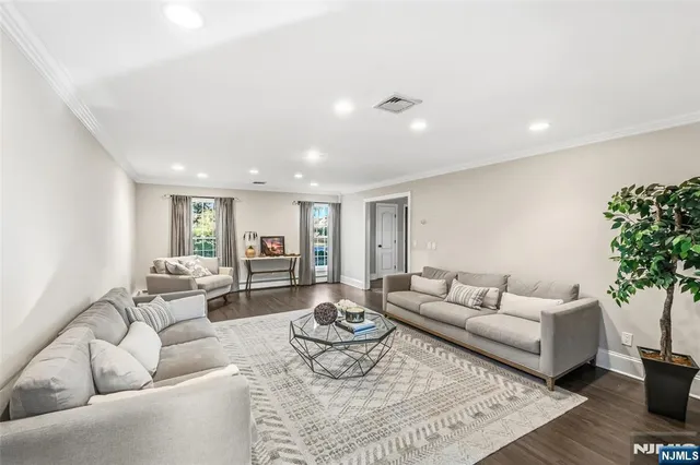 a living room with furniture and large windows