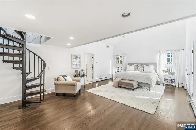 a bedroom with a large bed and a chandelier