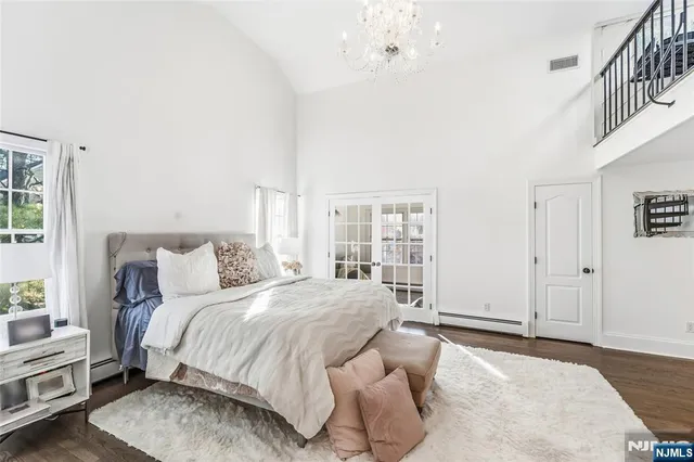 a bedroom with a bed and a chandelier