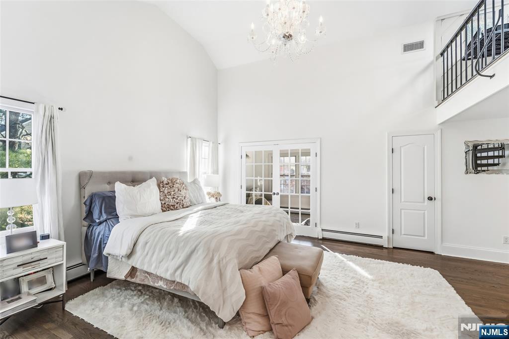 27 Pine Hill Road Old Tappan, NJ 07675 - Photo 26 of 50 a bedroom with a large bed and a chandelier