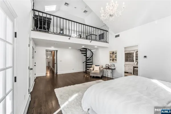 a bedroom with furniture and a wooden floor