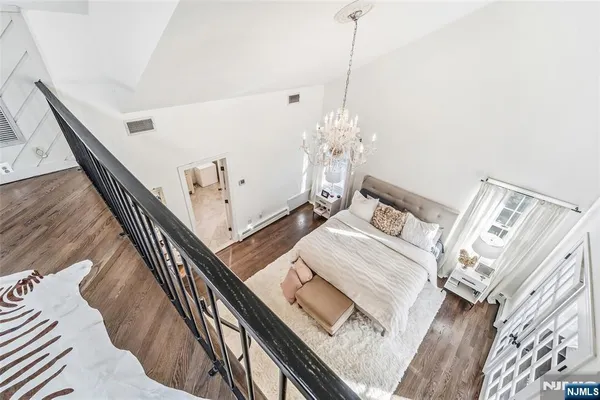 a bathroom with a double vanity sink a large mirror and a bathtub