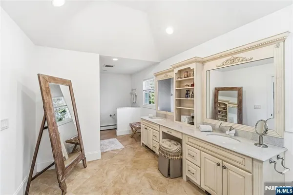 a large bathroom with a tub and shower