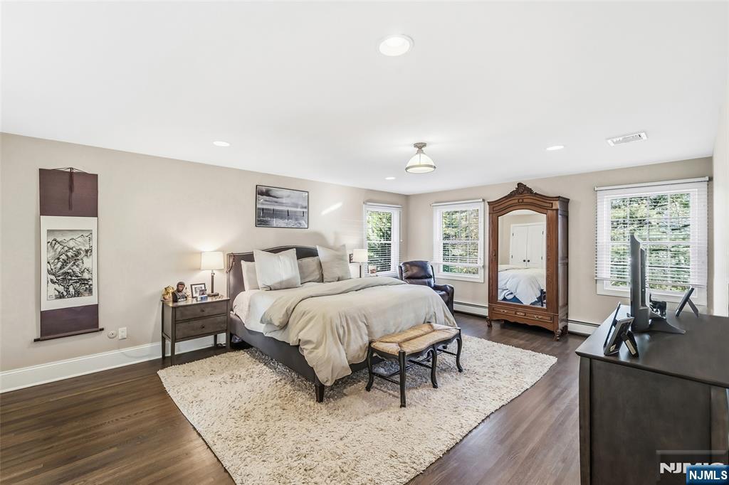 27 Pine Hill Road Old Tappan, NJ 07675 - Photo 39 of 50 a bed room with a bed couches and a flat tv screen