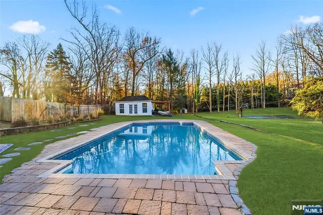 a view of a swimming pool with a yard