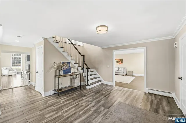 a view of a livingroom with wooden floor and stairs