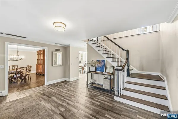 a view of entryway and hall with wooden floor