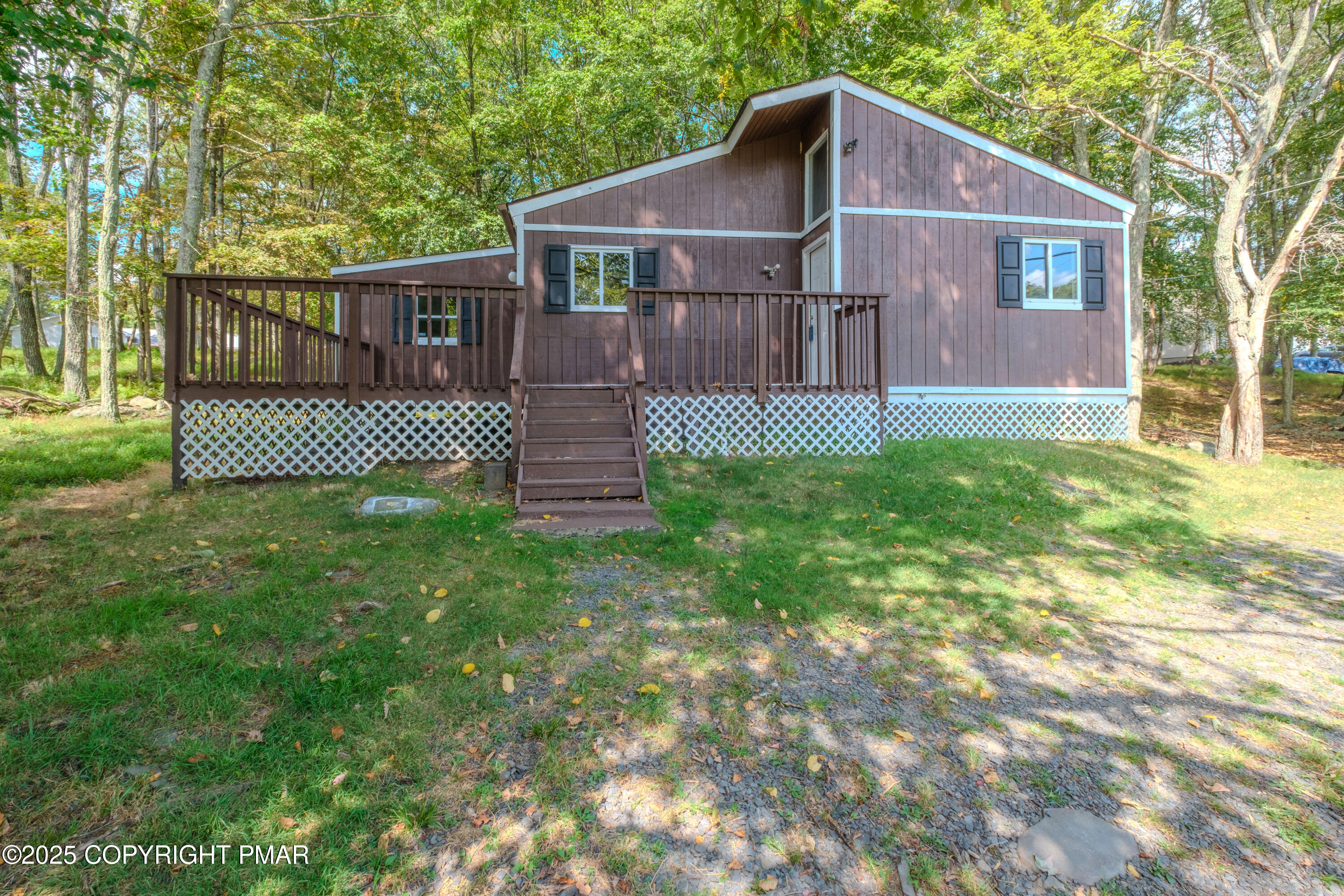 4774 Pine Ridge Drive West Bushkill, PA 18324 - Photo 12 of 36 a view of a house with a yard and deck