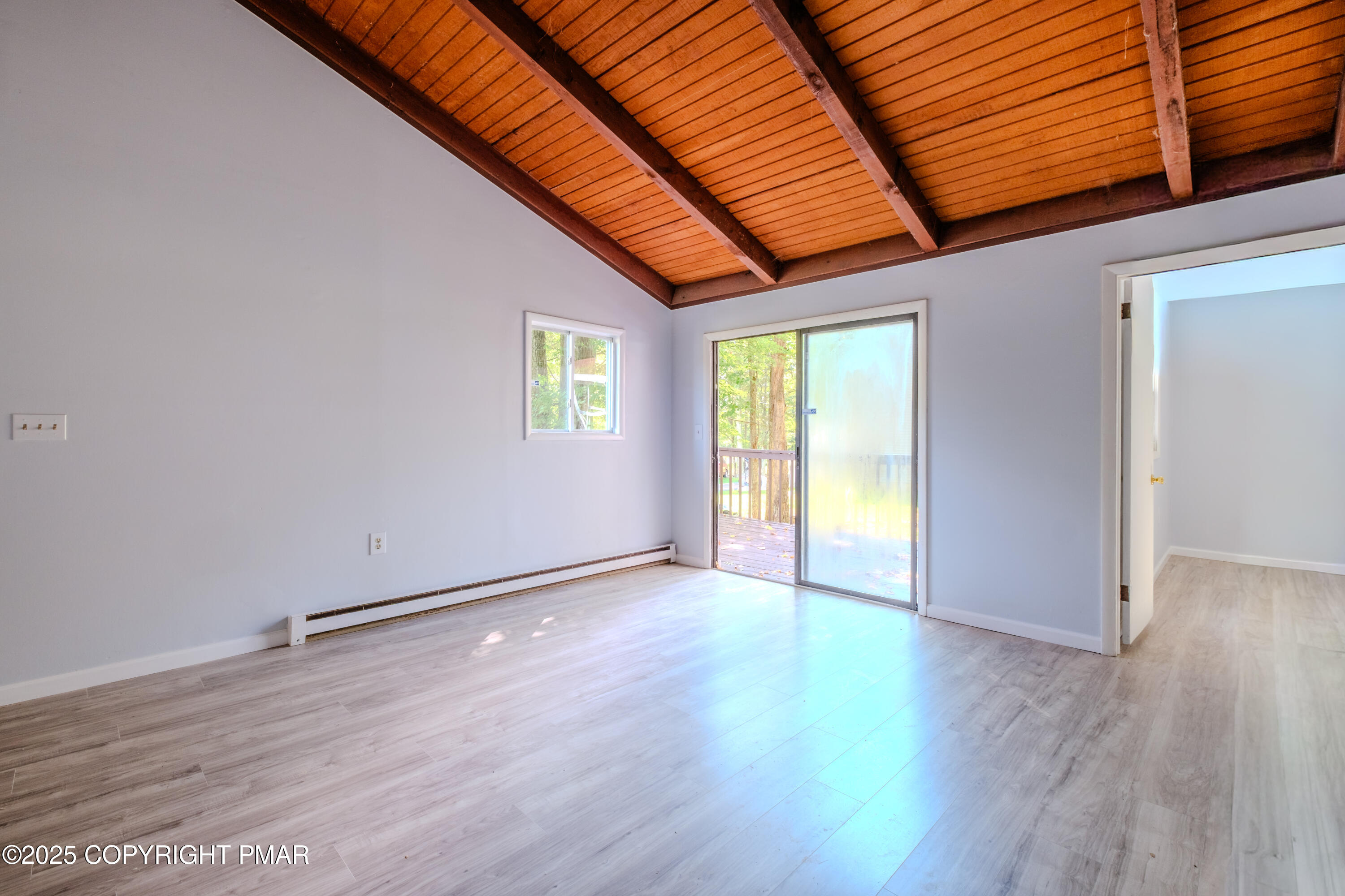 4774 Pine Ridge Drive West Bushkill, PA 18324 - Photo 30 of 36 an empty room with wooden floor and windows