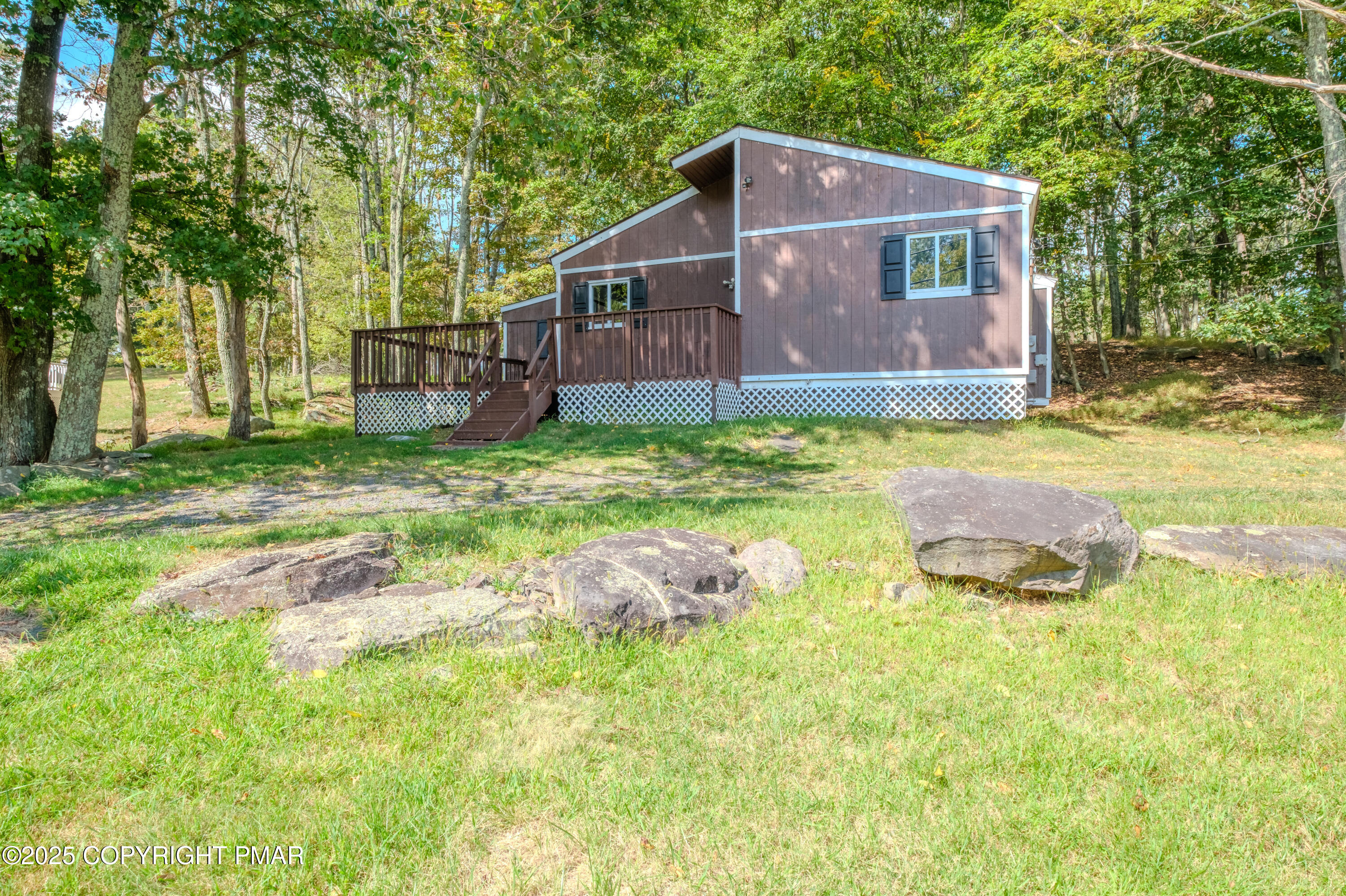 4774 Pine Ridge Drive West Bushkill, PA 18324 - Photo 5 of 36 a backyard of a house with table and chairs