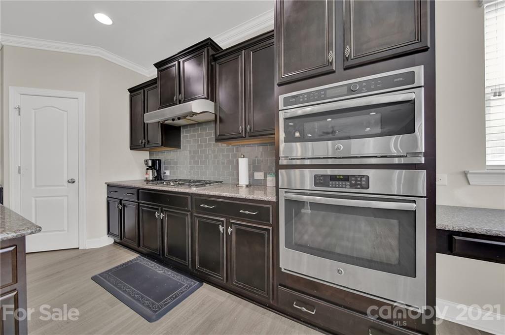 813 Bridge View Court Fort Mill, SC 29708 - Photo 14 of 42 a kitchen with stainless steel appliances granite countertop a stove and a microwave