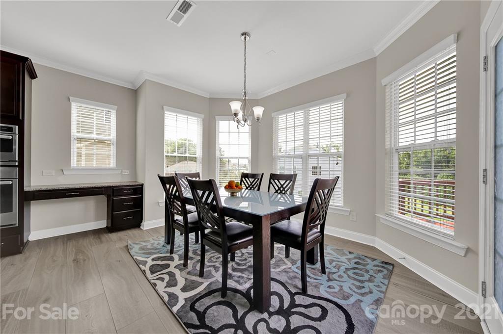 813 Bridge View Court Fort Mill, SC 29708 - Photo 16 of 42 a view of a dining room with furniture window and wooden floor