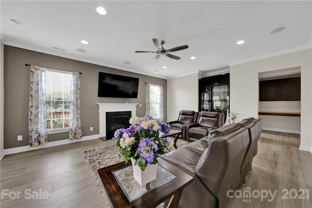 813 Bridge View Court Fort Mill, SC 29708 - Photo 18 of 42 a living room with furniture a flat screen tv and a fireplace
