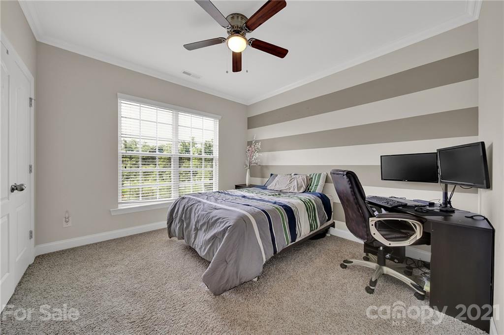 813 Bridge View Court Fort Mill, SC 29708 - Photo 21 of 42 a bedroom with a bed and a flat screen tv