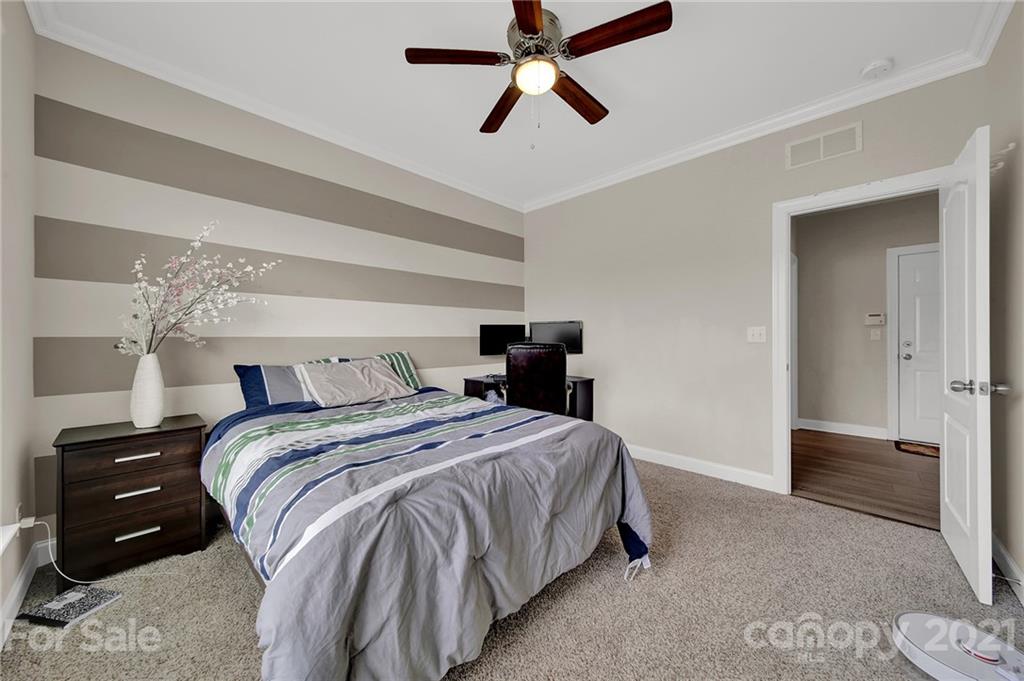 813 Bridge View Court Fort Mill, SC 29708 - Photo 22 of 42 a bedroom with a bed and a ceiling fan