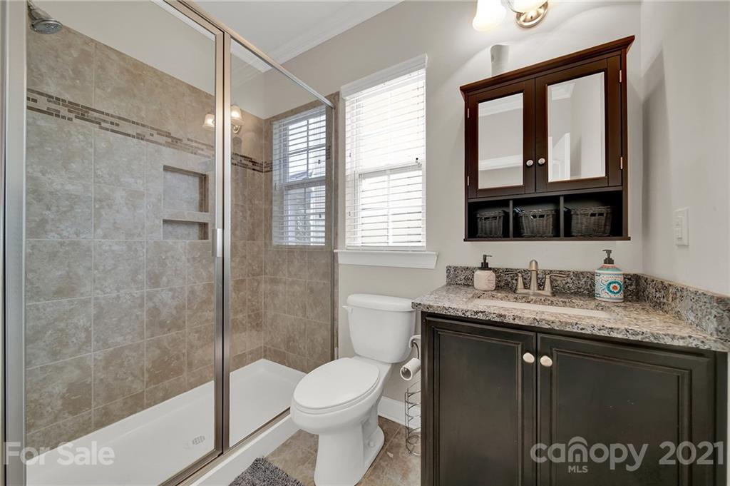 813 Bridge View Court Fort Mill, SC 29708 - Photo 23 of 42 a bathroom with a granite countertop sink toilet and shower