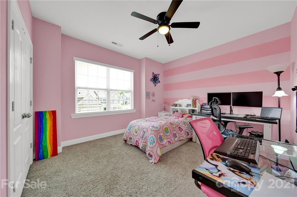 813 Bridge View Court Fort Mill, SC 29708 - Photo 26 of 42 a bed room with a bed a flat screen tv and a window
