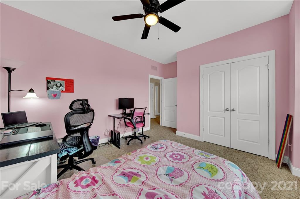 813 Bridge View Court Fort Mill, SC 29708 - Photo 27 of 42 a bedroom with a bed a desk and chair