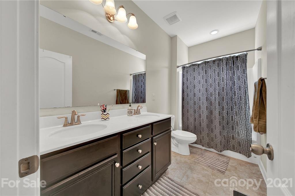 813 Bridge View Court Fort Mill, SC 29708 - Photo 28 of 42 a bathroom with a double vanity sink toilet and a mirror