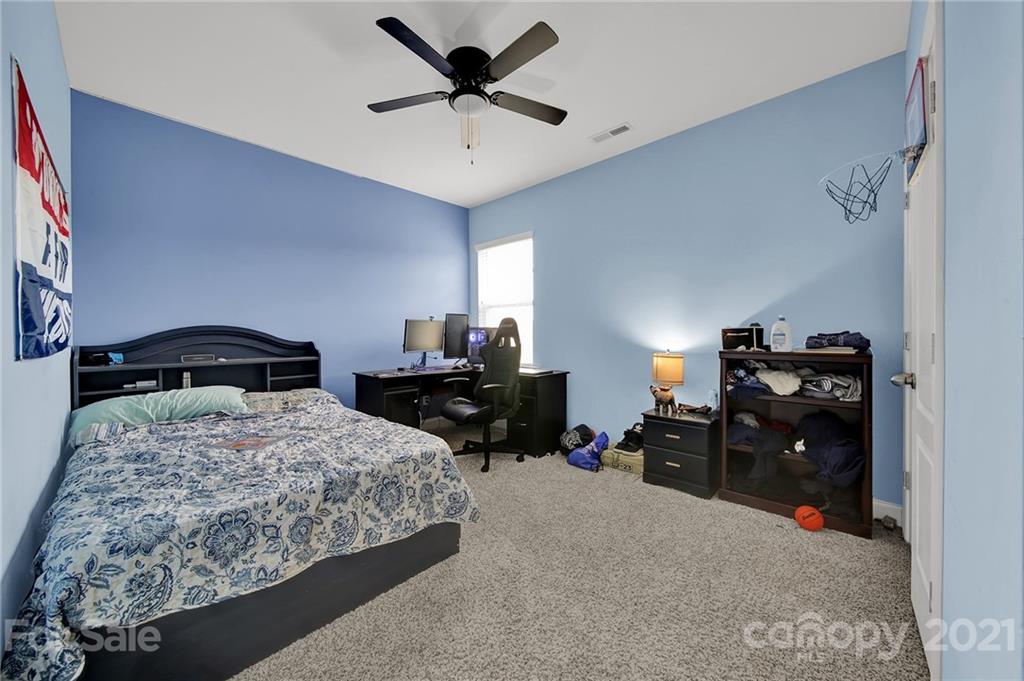813 Bridge View Court Fort Mill, SC 29708 - Photo 29 of 42 a bedroom with a bed and a chandelier