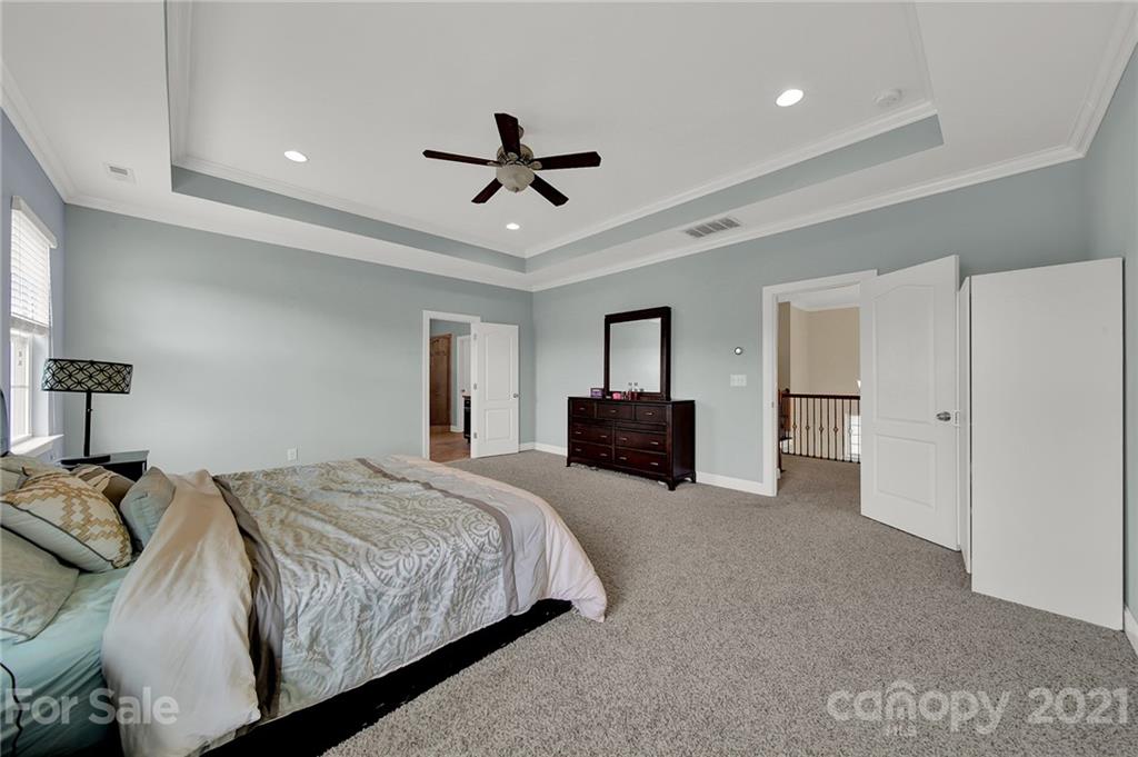 813 Bridge View Court Fort Mill, SC 29708 - Photo 31 of 42 a spacious bedroom with a bed and a ceiling fan