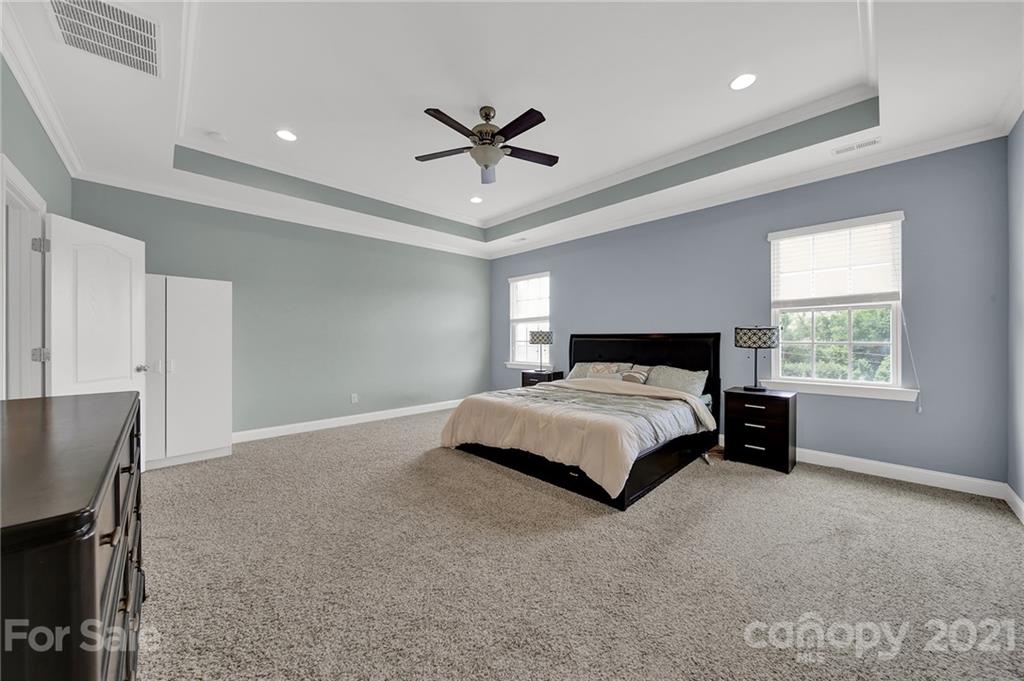 813 Bridge View Court Fort Mill, SC 29708 - Photo 32 of 42 a spacious bedroom with a bed and a ceiling fan