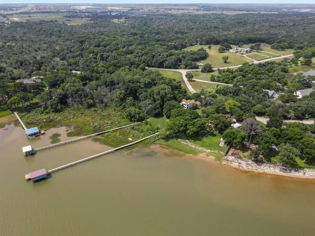 an aerial view of residential houses with outdoor space and parking
