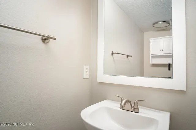 a bathroom with a sink and mirror