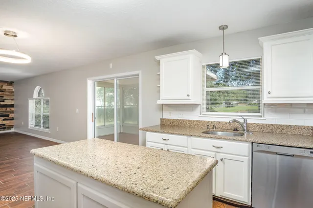a kitchen with a sink stove and cabinets